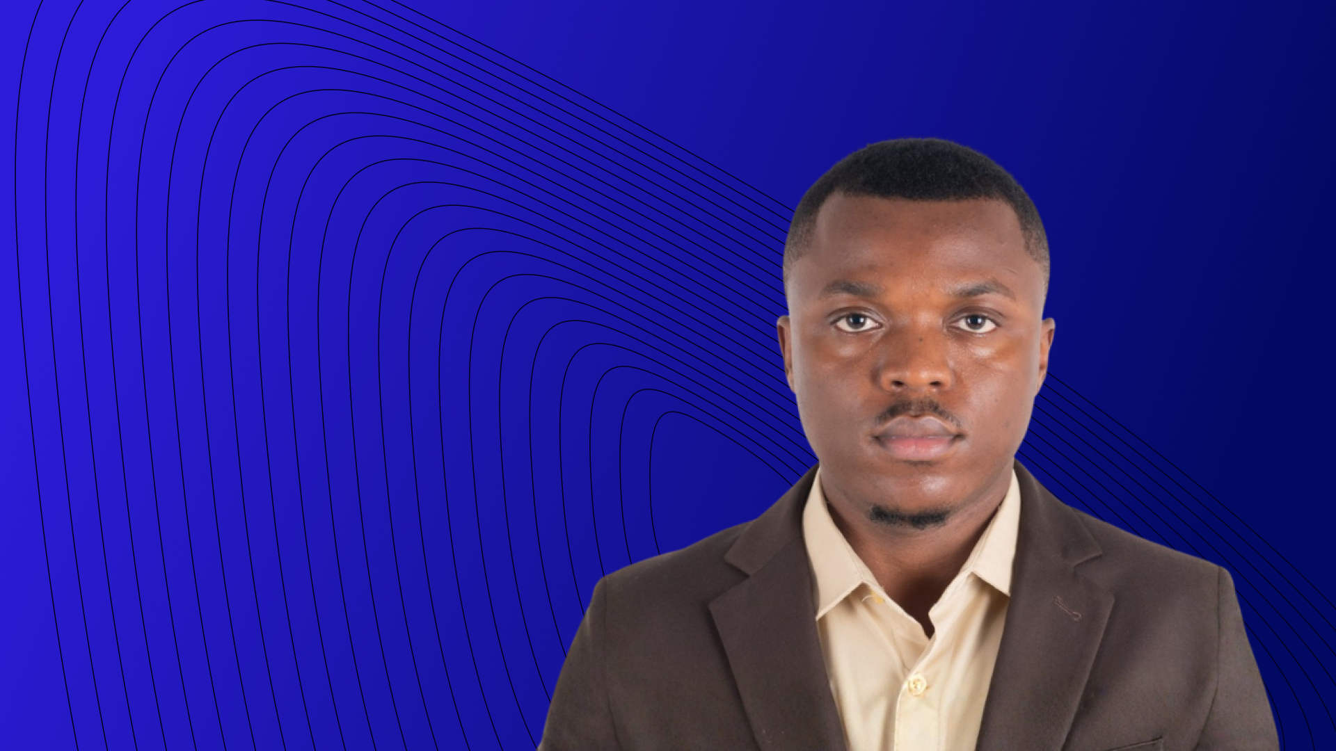 Man in front of a blue background, looking at the camera